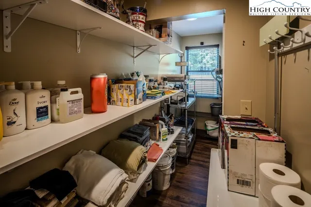 a kitchen with a table chairs and a wooden floor
