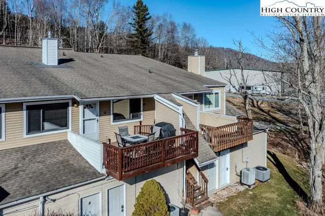 a view of balcony with wooden floor and outdoor seating