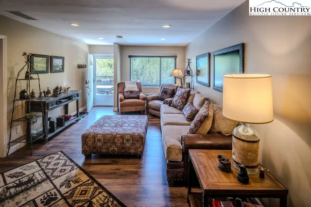 a living room with furniture and a wooden floor