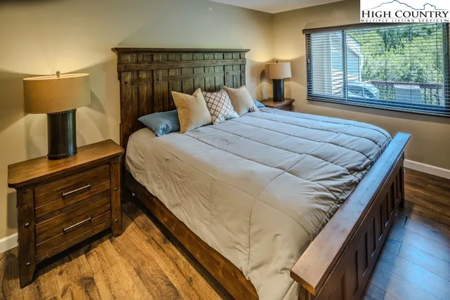 a bed sitting in a bedroom next to a window