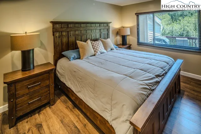 a bed sitting in a bedroom next to a window