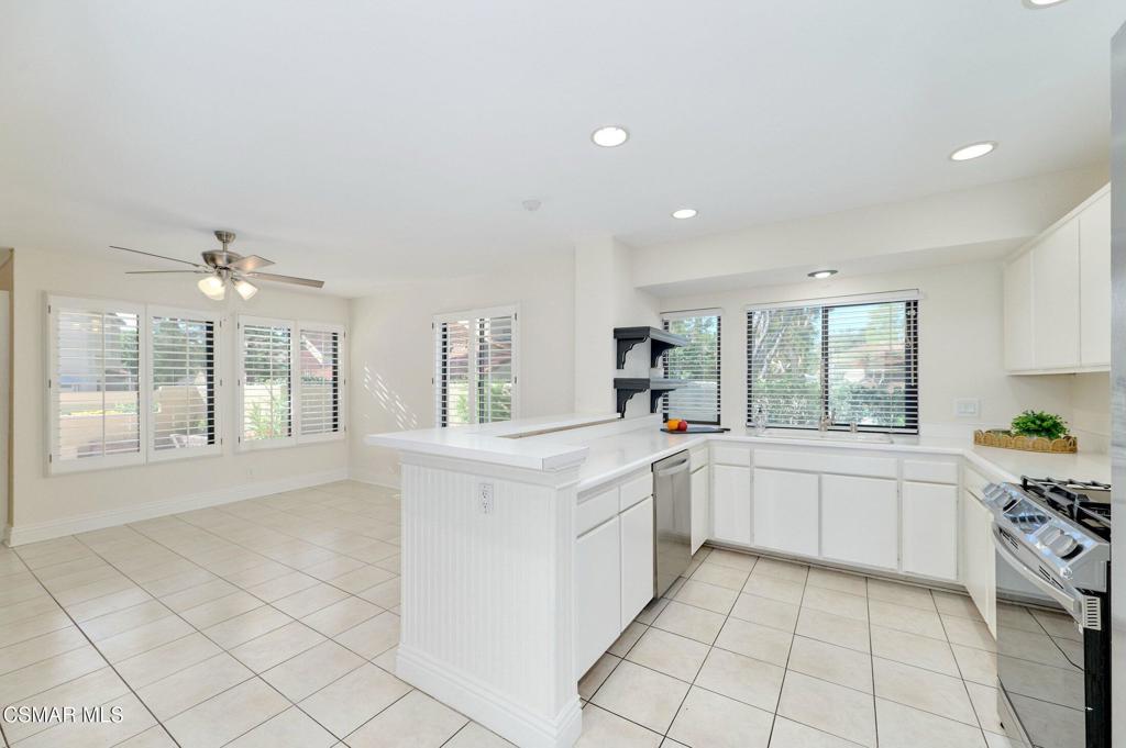 5368 Rainwood Street, Unit 65 Simi Valley, CA 93063 - Photo 12 of 34 a large white kitchen with cabinets and a window