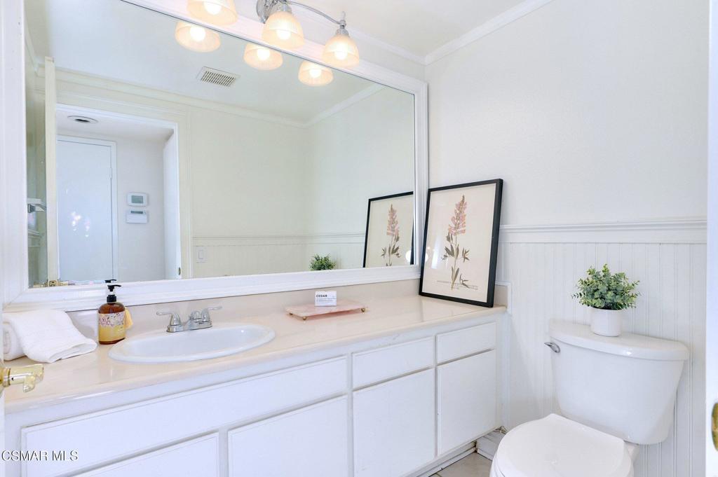 5368 Rainwood Street, Unit 65 Simi Valley, CA 93063 - Photo 16 of 34 a bathroom with a toilet sink and mirror