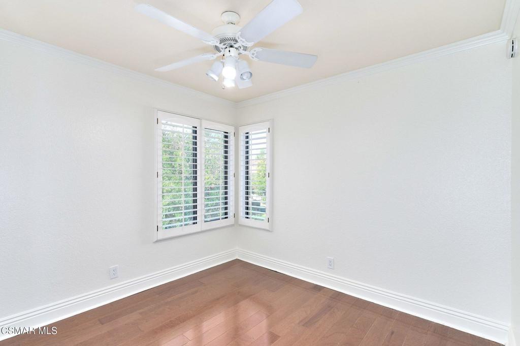 5368 Rainwood Street, Unit 65 Simi Valley, CA 93063 - Photo 21 of 34 an empty room with a chandelier fan and windows