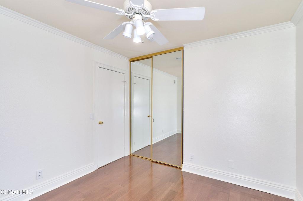 5368 Rainwood Street, Unit 65 Simi Valley, CA 93063 - Photo 22 of 34 an empty room with wooden floor fan and windows