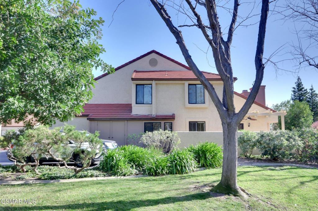 5368 Rainwood Street, Unit 65 Simi Valley, CA 93063 - Photo 30 of 34 a front view of a house with a yard