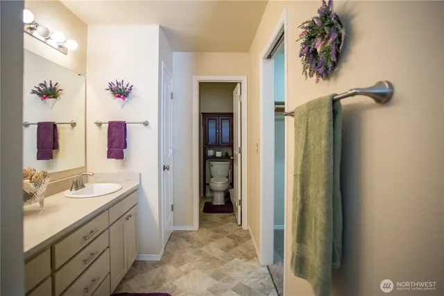 a bathroom with a sink vanity and a mirror