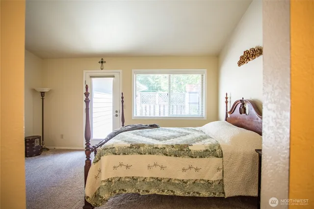 a bedroom with a bed and a window