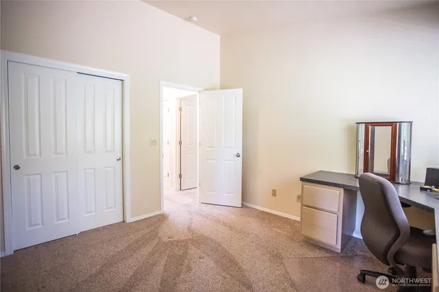a view of workspace with furniture and closet