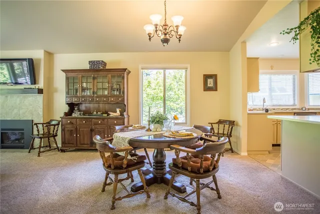 a dining room with furniture a chandelier and window