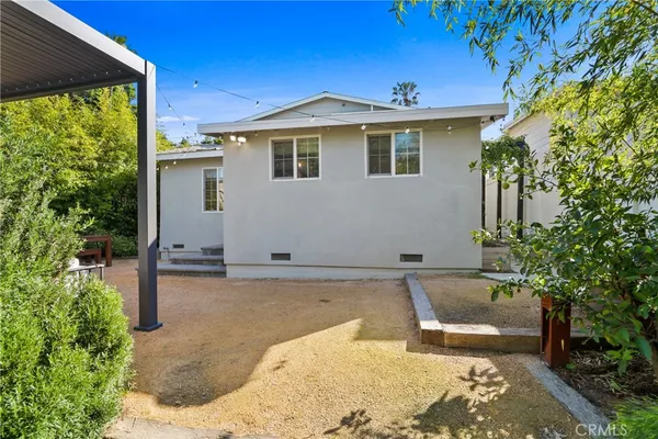 a view of a house with pool and sitting area