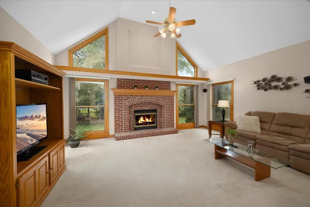 a living room with furniture a flat screen tv and a fireplace