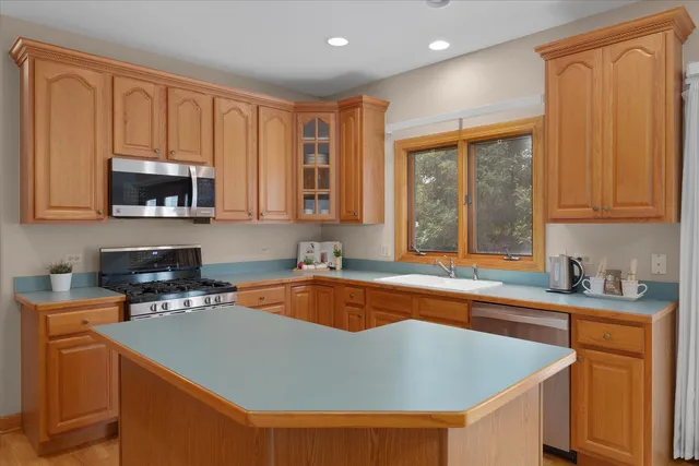 a kitchen with a sink a stove and a microwave