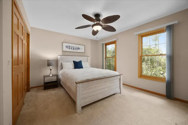 a bedroom with a large bed and a chandelier