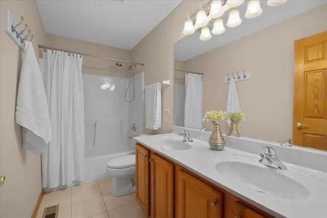 a bathroom with a granite countertop sink a toilet and a large mirror