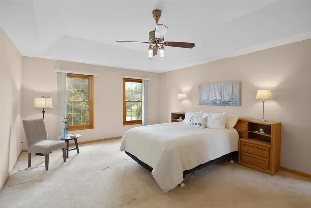 a bedroom with a bed lamps and window