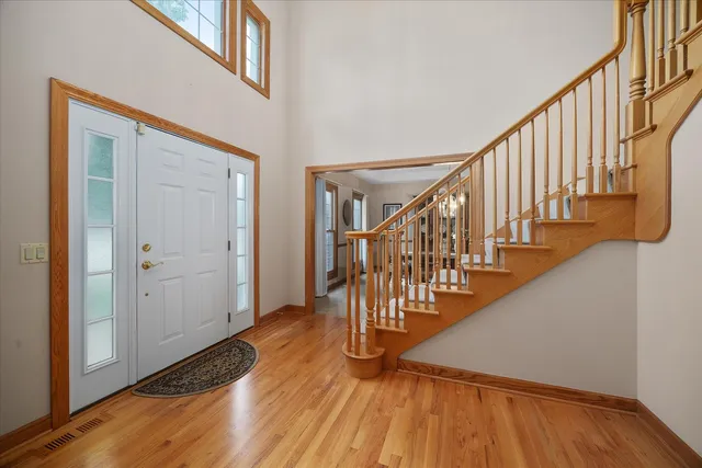 a view of entryway with wooden floor and stairs