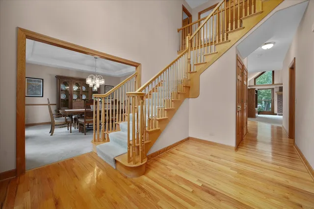 a view of entryway and hall with wooden floor