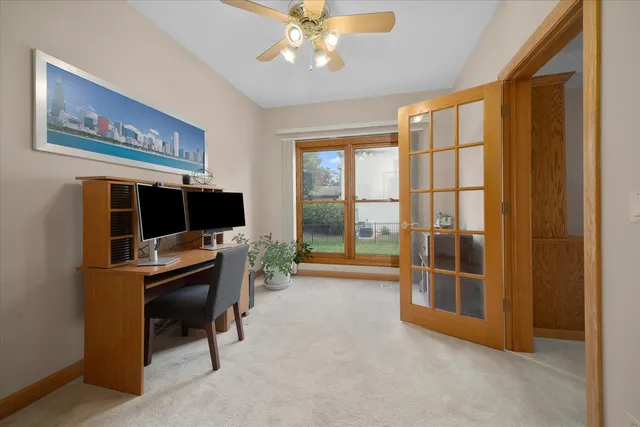 a view of a livingroom with workspace and a window