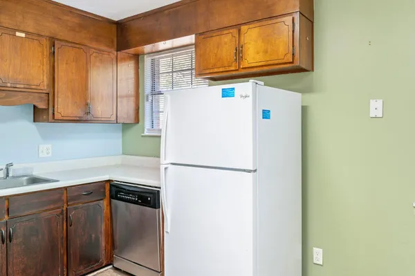 a white refrigerator freezer sitting inside of a kitchen