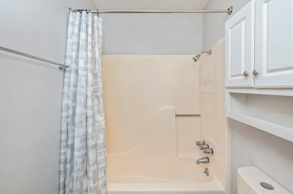 a bathroom with a shower and a tub