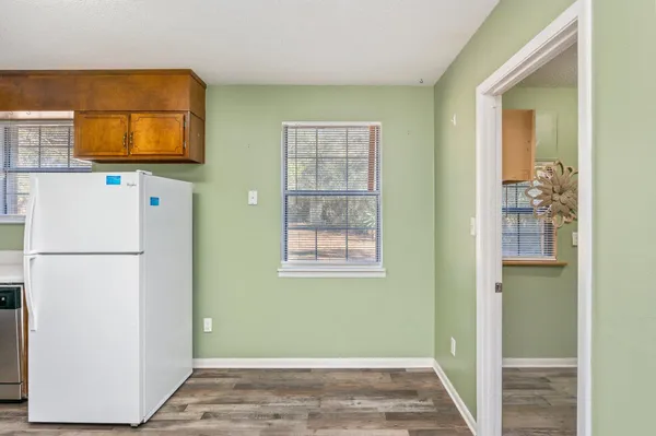 a view of a bathroom with a sink and a refrigerator