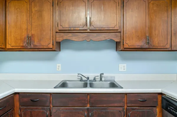 a kitchen with a sink and cabinets