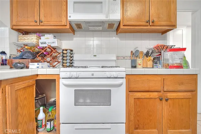 a kitchen with stainless steel appliances granite countertop a refrigerator and cabinets
