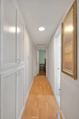a view of a hallway with wooden floor