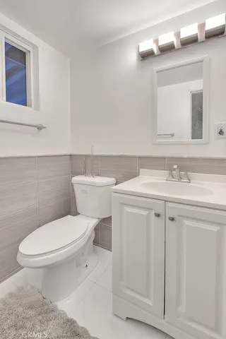 a white toilet sitting next to a bathroom sink