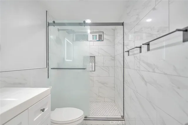 a bathroom with a shower a toilet and sink