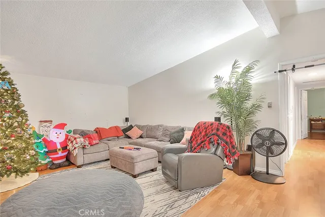 a living room with furniture and many potted plants
