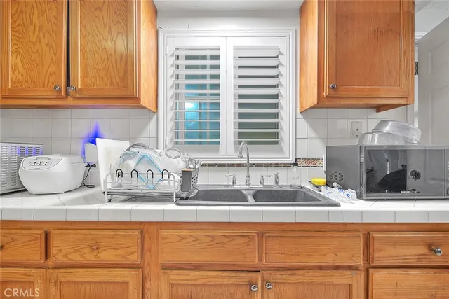 a kitchen with granite countertop a sink and a white cabinets