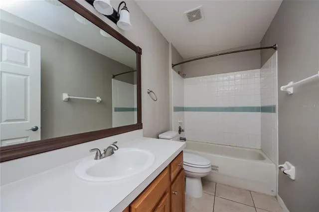 a bathroom with a sink toilet tub and shower