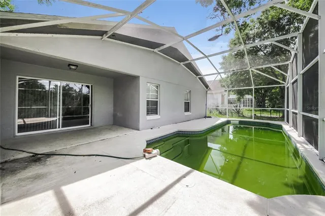 a view of a backyard with a swimming pool