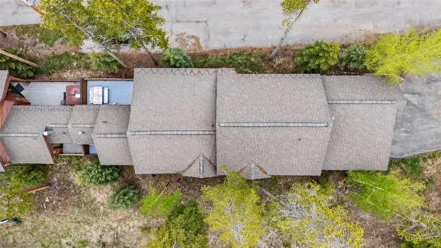 an aerial view of a house with garden space and sitting area
