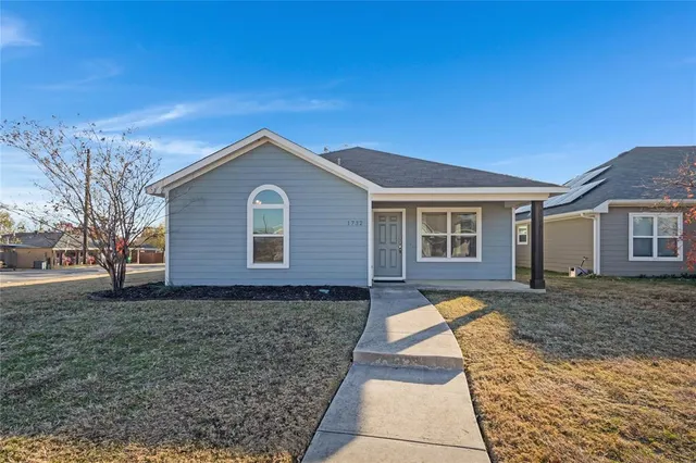 a front view of a house with yard