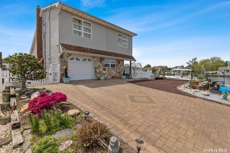 40 Flint Road Amity Harbor, NY 11701 - Photo 1 of 1 a front view of a house with a yard