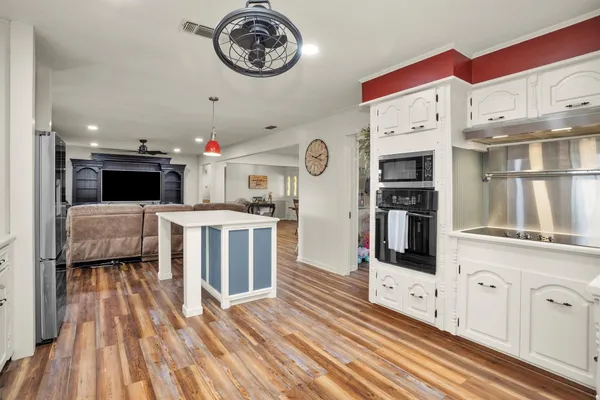 a view of a backyard with table and chairs under an umbrella