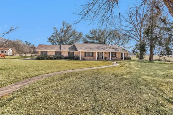 a living room with furniture windows and wooden floor