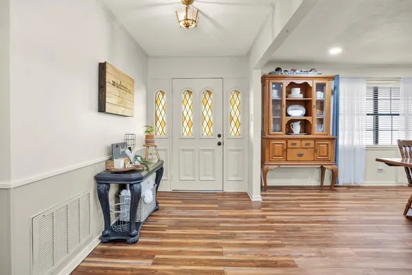 a view of a dining room with furniture and wooden floor