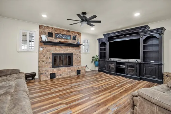 a kitchen with stainless steel appliances white cabinets and wooden floor
