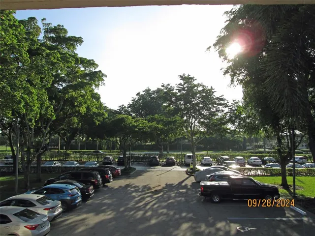 a view of cars parked on a street side