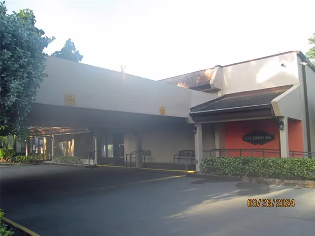 a view of a house with pool and a yard