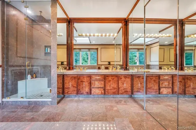 a spacious bathroom with a toilet sink and mirror