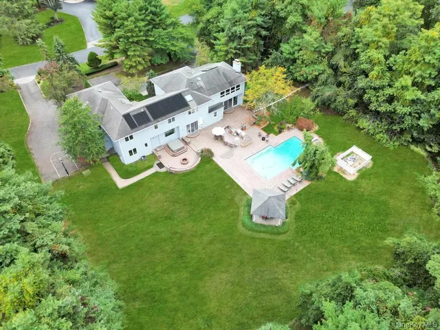an aerial view of a house with backyard