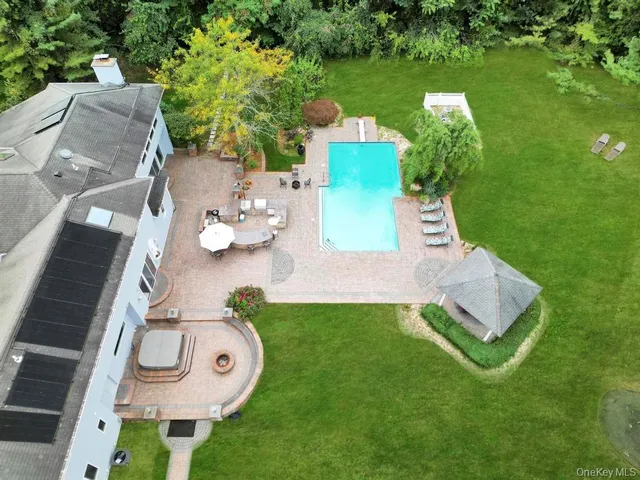 a view of a house with backyard sitting area and garden