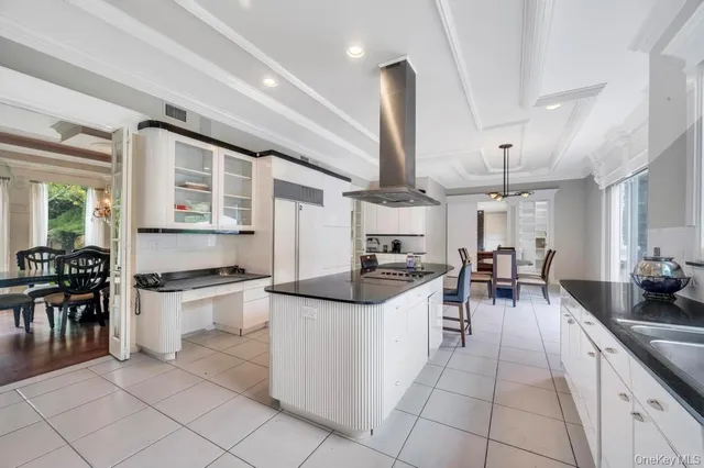 a kitchen with stainless steel appliances kitchen island granite countertop a sink and cabinets