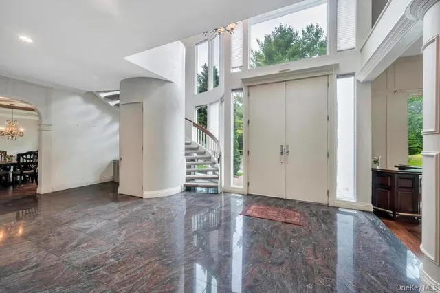 a living room with furniture potted plant and a large window