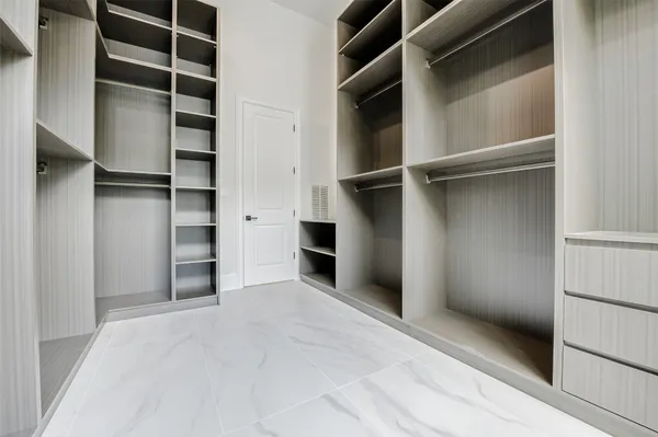 a view of a big room with windows and chandelier